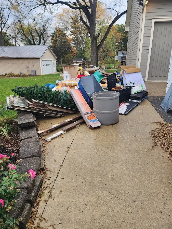 Dumpster being loaded with debris for 12 Yard Dumpster Rental in West Milton